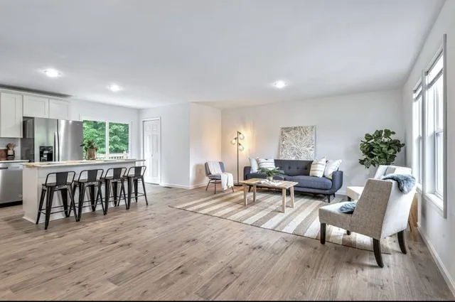a living room with furniture and floor to ceiling windows