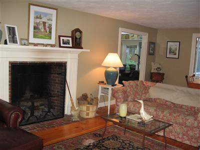 263 Service Road East Sandwich, MA 02537 - Photo 3 of 13 a living room with table chairs and a fireplace