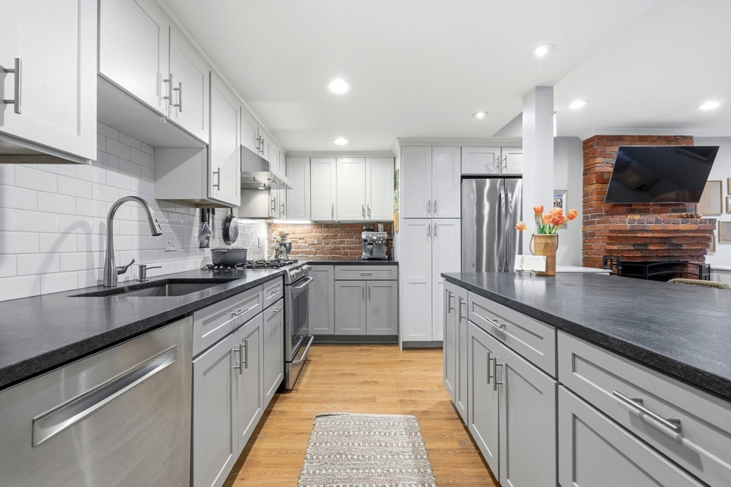 35 High Street, Unit 1 Boston, MA 02129 - Photo 21 of 33 a large kitchen with stainless steel appliances kitchen island granite countertop a sink and cabinets