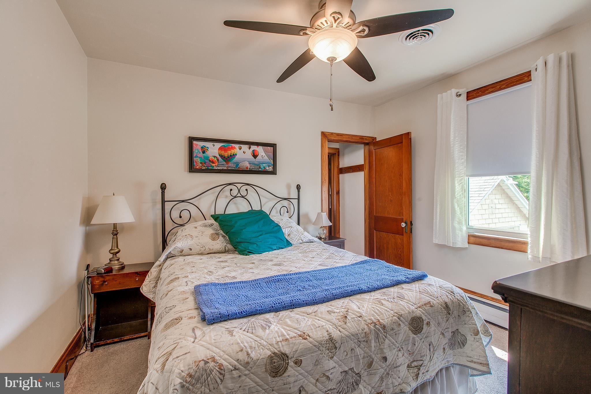 8317 Myersville Road Middletown, MD 21769 - Photo 19 of 30 a bedroom with a large bed and a tv