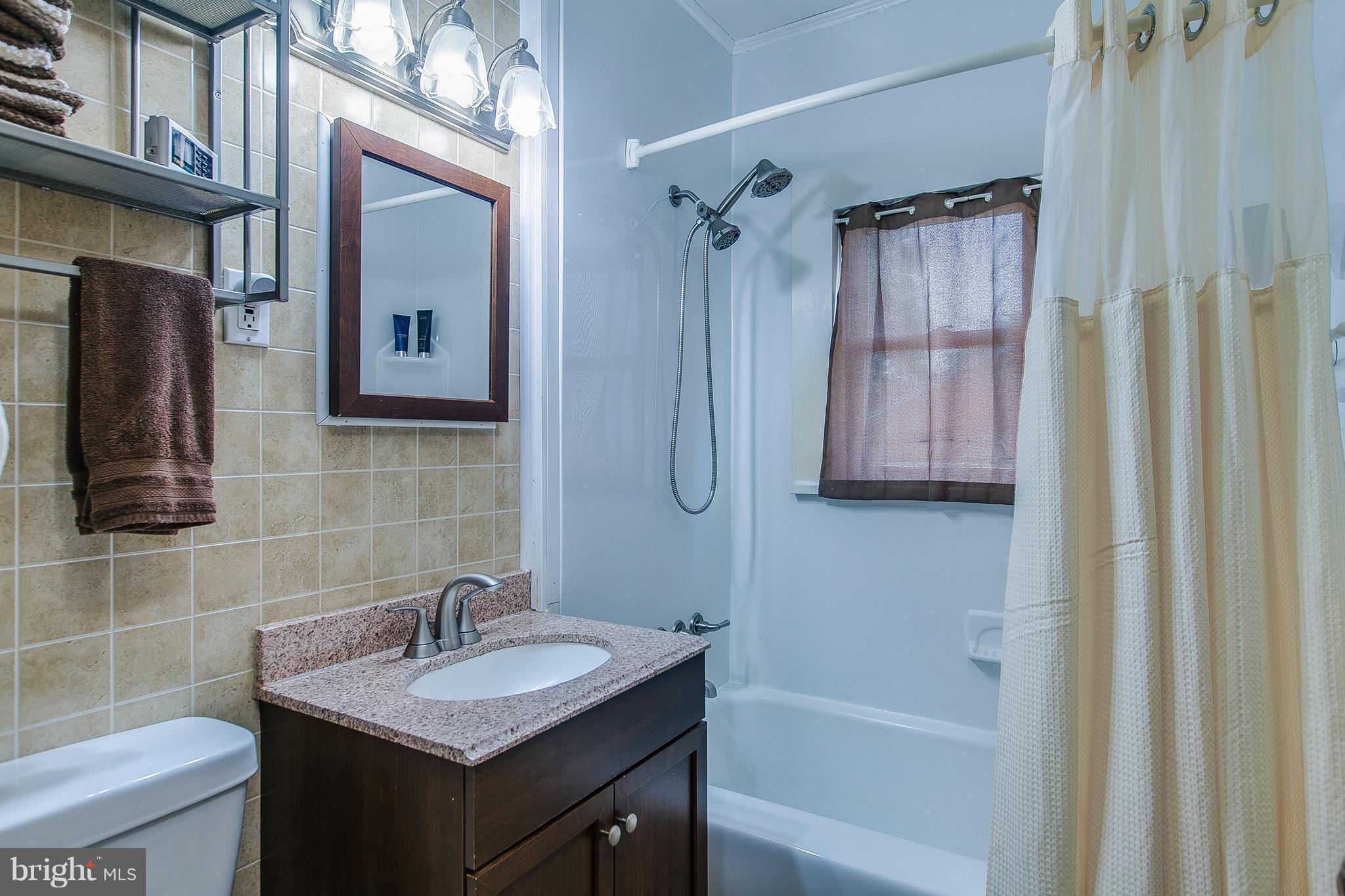 8317 Myersville Road Middletown, MD 21769 - Photo 22 of 30 a bathroom with a sink a toilet and shower