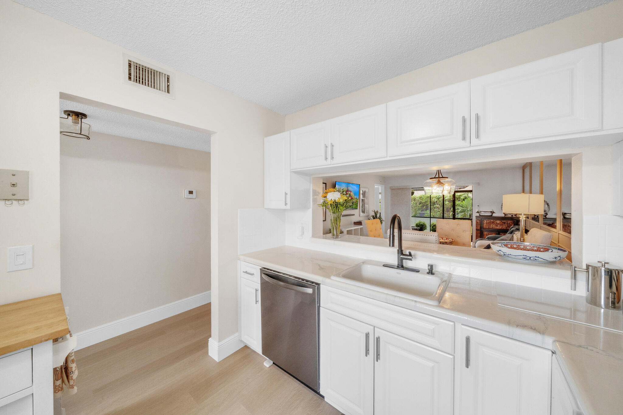 22136 Palms Way, Unit 103 Boca Raton, FL 33433 - Photo 7 of 42 a kitchen with stainless steel appliances granite countertop a sink and a white cabinets