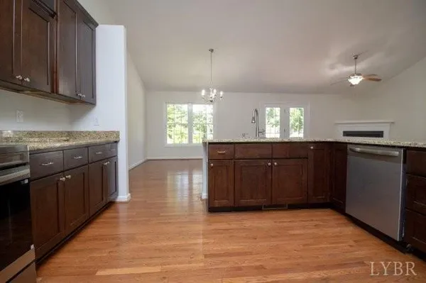 a kitchen with stainless steel appliances granite countertop a stove a sink dishwasher and a refrigerator