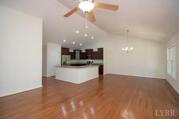 a view of kitchen with refrigerator and microwave