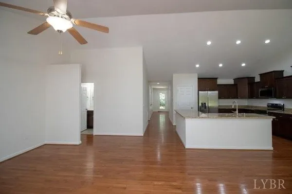 a view of kitchen with sink and refrigerator