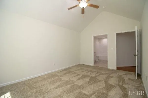 an empty room with a chandelier fan