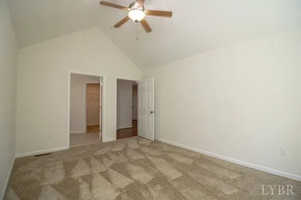 a view of a room with a chandelier fan and closet
