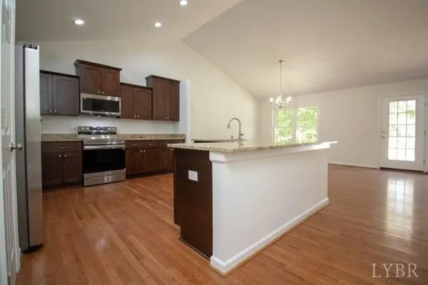 a kitchen with stainless steel appliances granite countertop a sink and stove top oven