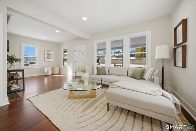 a living room with furniture and a wooden floor