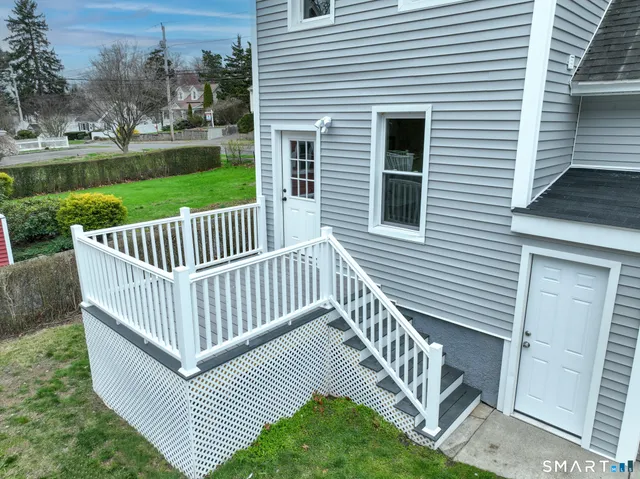 a view of a roof deck with wooden fence and a floor
