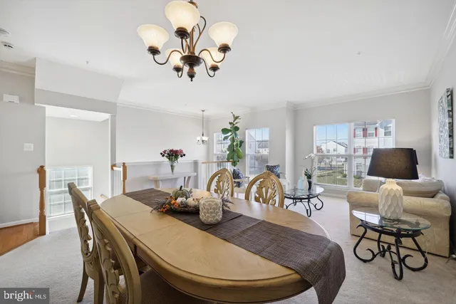 a view of a dining room with furniture and chandelier