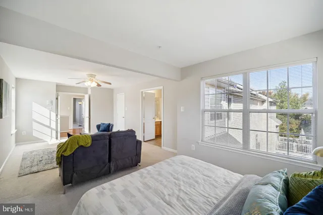 a bedroom with a large bed and a large window
