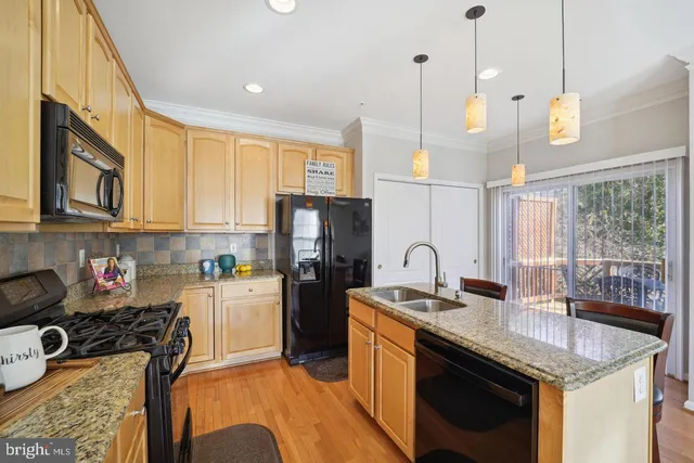 a kitchen with refrigerator cabinets and stove
