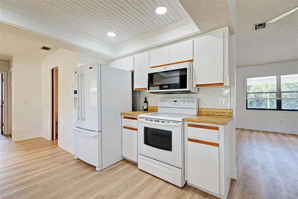 a kitchen with stainless steel appliances a stove a refrigerator and a microwave