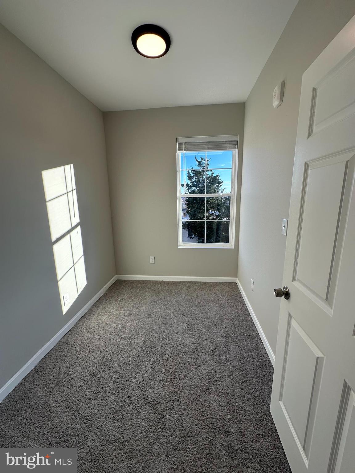 1812 H Place Northeast, Unit 304 Washington, DC 20002 - Photo 11 of 13 an empty room with windows