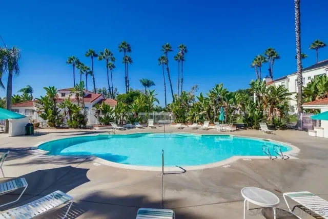 a view of a swimming pool with an outdoor space and seating area