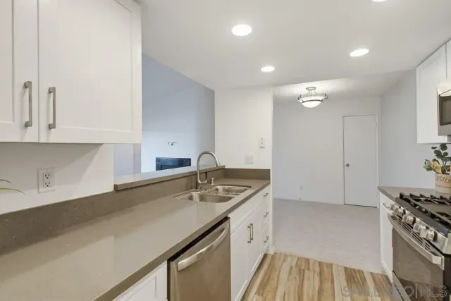 a kitchen with a sink stove and cabinets