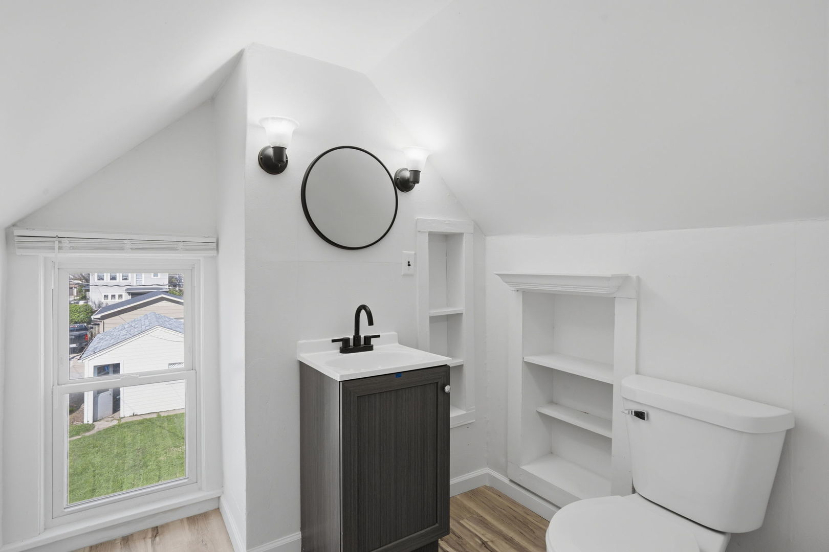 1927 14th Street Moline, IL 61265 - Photo 17 of 25 a bathroom with a toilet a sink and a mirror