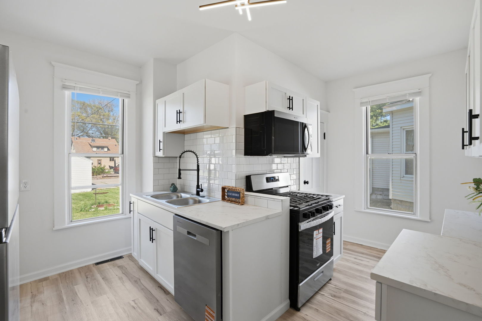 1927 14th Street Moline, IL 61265 - Photo 9 of 25 a kitchen with a sink stove and microwave