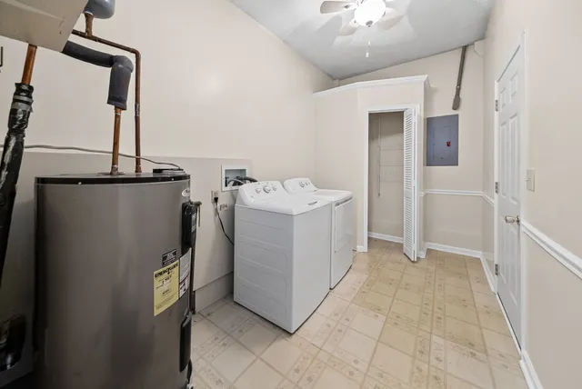 a utility room with cabinets and washer