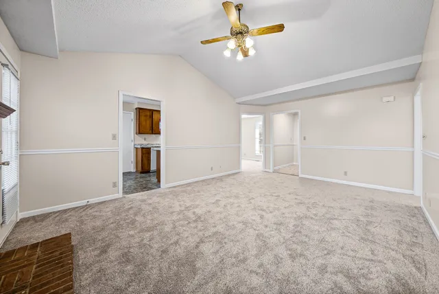 a view of empty room with ceiling fan