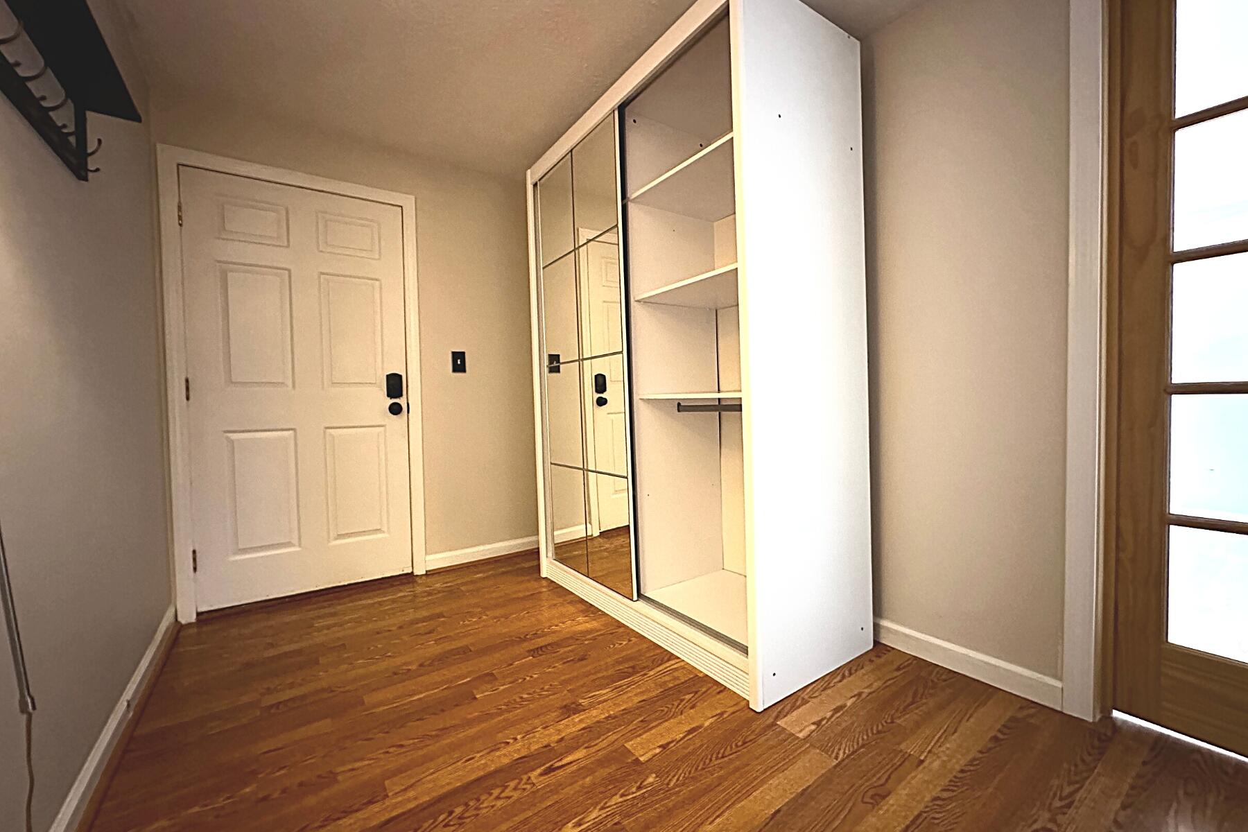 70 North Street, Unit E Hyannis, MA 02601 - Photo 12 of 29 a view of an empty room with wooden floor and a window