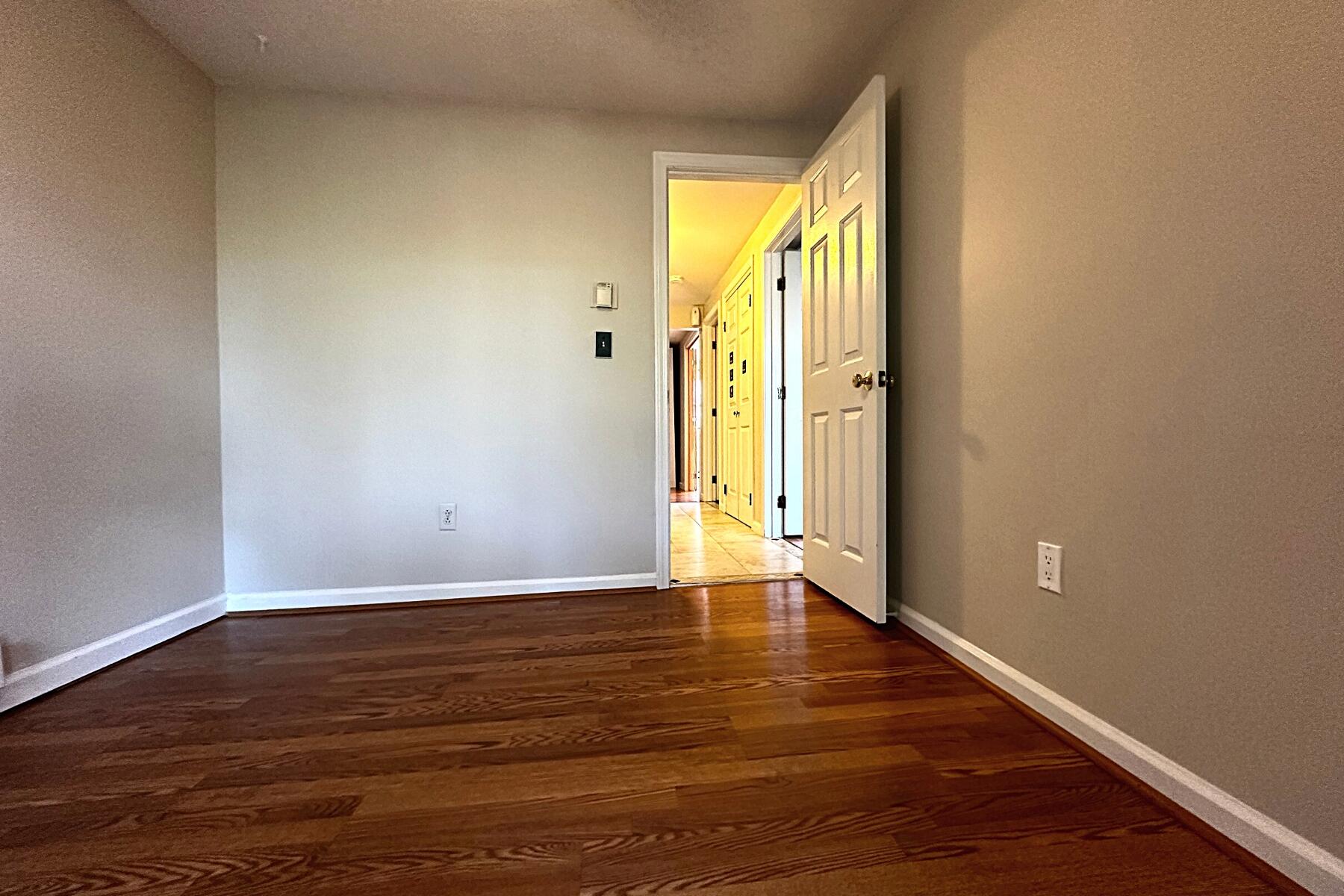 70 North Street, Unit E Hyannis, MA 02601 - Photo 17 of 29 a view of an empty room with wooden floor and a window