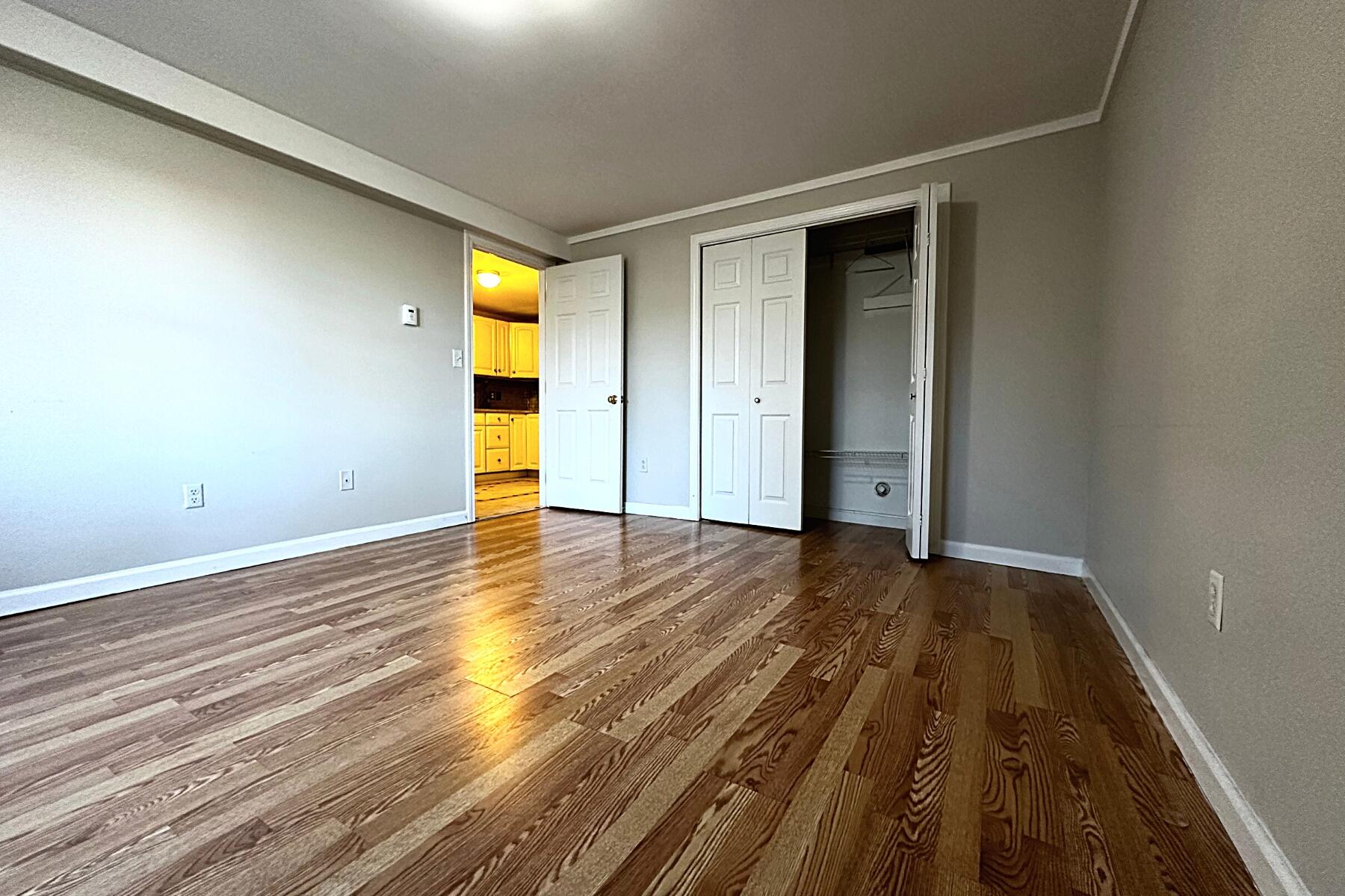 70 North Street, Unit E Hyannis, MA 02601 - Photo 18 of 29 a view of an empty room and wooden floor