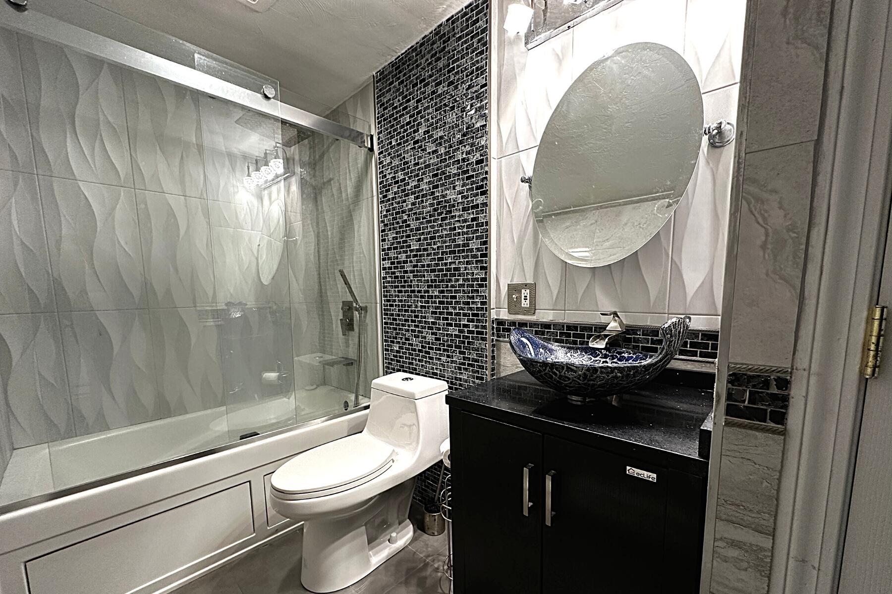 70 North Street, Unit E Hyannis, MA 02601 - Photo 7 of 29 a bathroom with a sink toilet and shower