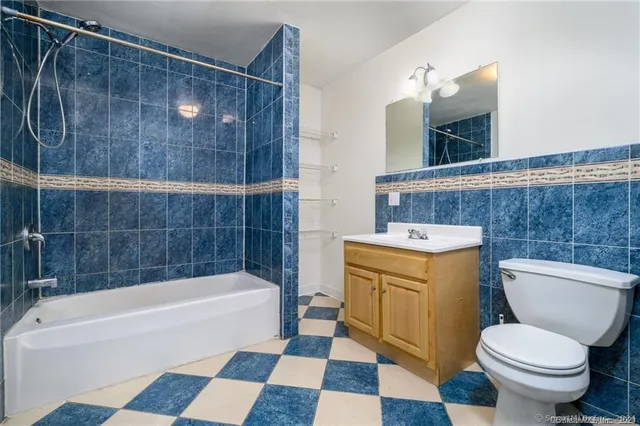 a bathroom with a toilet a sink and bathtub