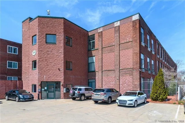 a car parked in front of a brick building