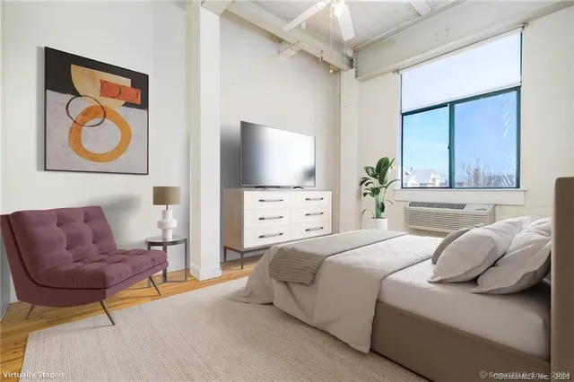 a bedroom with a bed and a couch