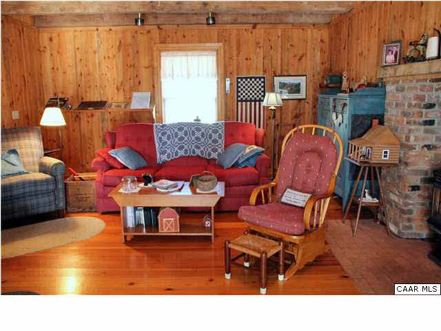 Heart pine floors and pine paneling warm the large family room.
