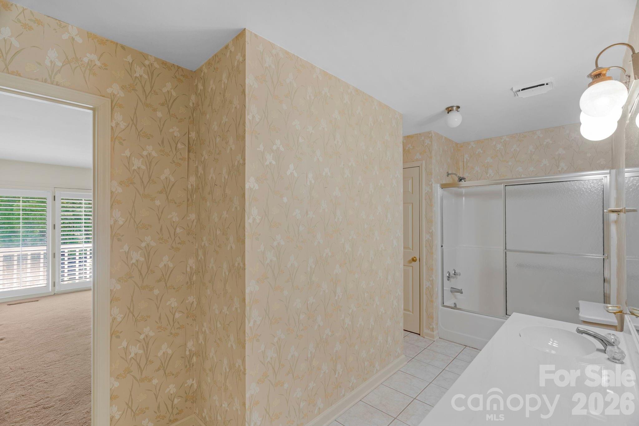 15015 Pawnee Trail Matthews, NC 28104 - Photo 15 of 39 a bathroom with a shower and a sink