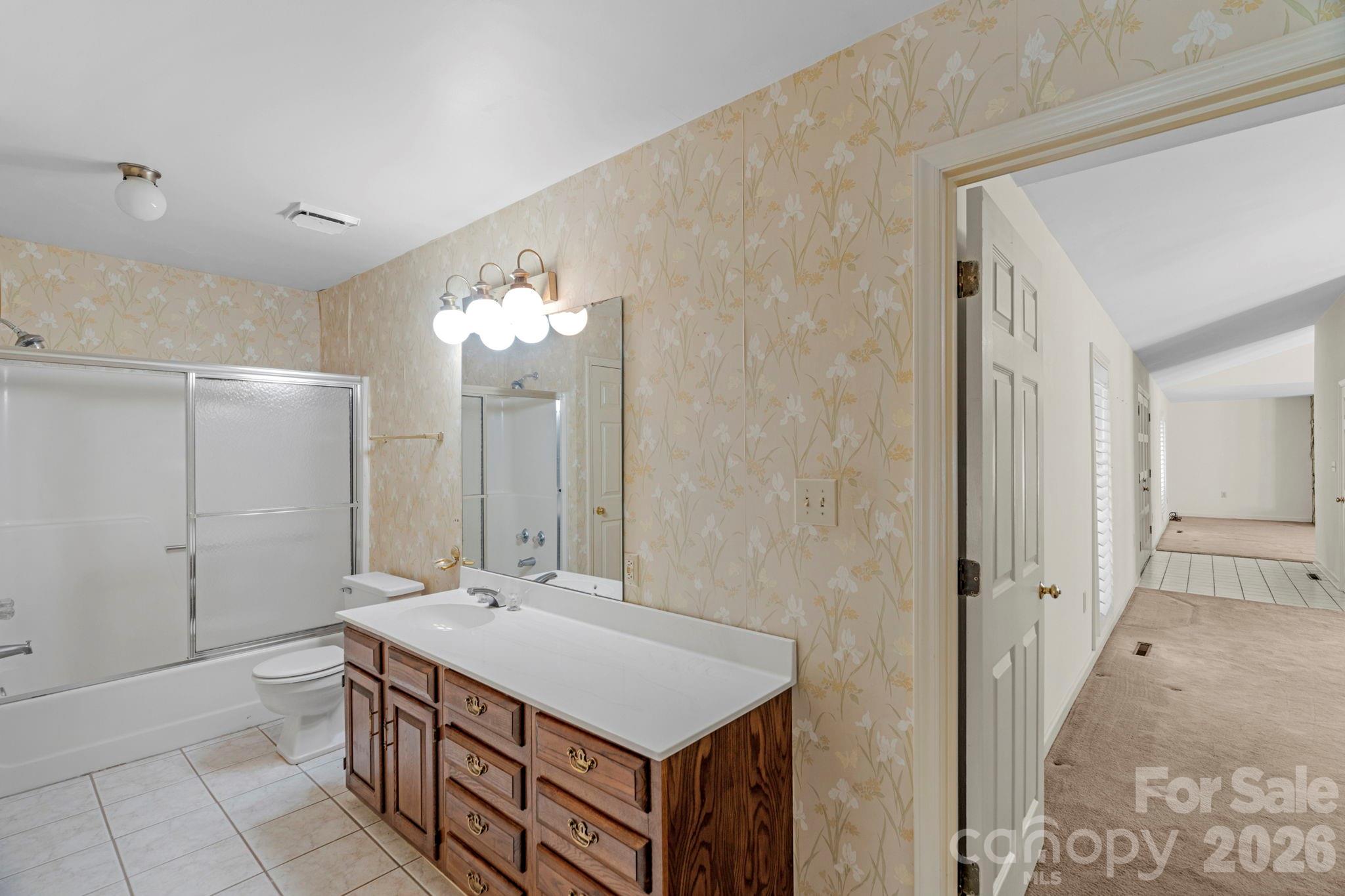 15015 Pawnee Trail Matthews, NC 28104 - Photo 19 of 39 a bathroom with a sink a mirror and a shower