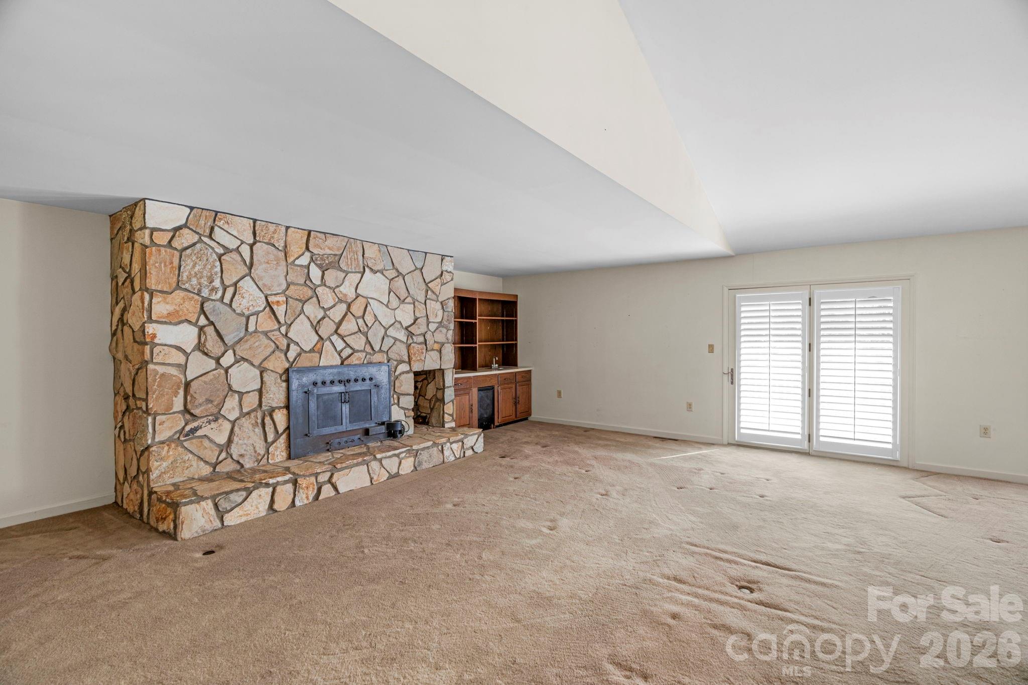 15015 Pawnee Trail Matthews, NC 28104 - Photo 2 of 39 an empty room with fireplace and windows