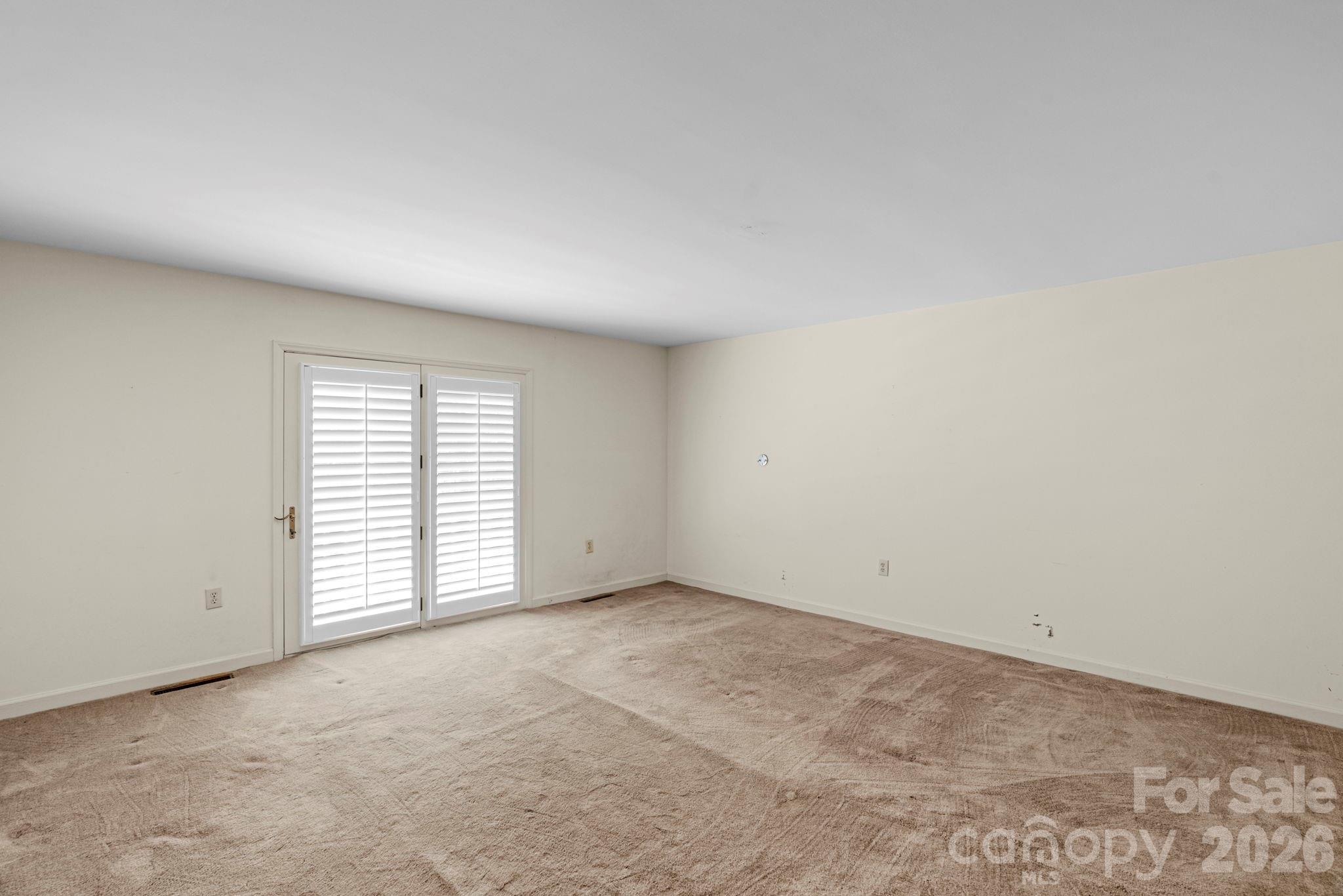 15015 Pawnee Trail Matthews, NC 28104 - Photo 21 of 39 an empty room with windows