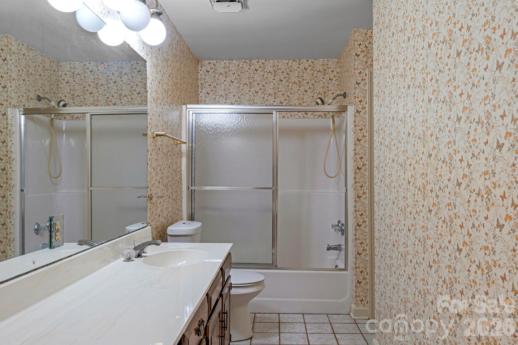 15015 Pawnee Trail Matthews, NC 28104 - Photo 24 of 39 a bathroom with a sink a mirror and a shower