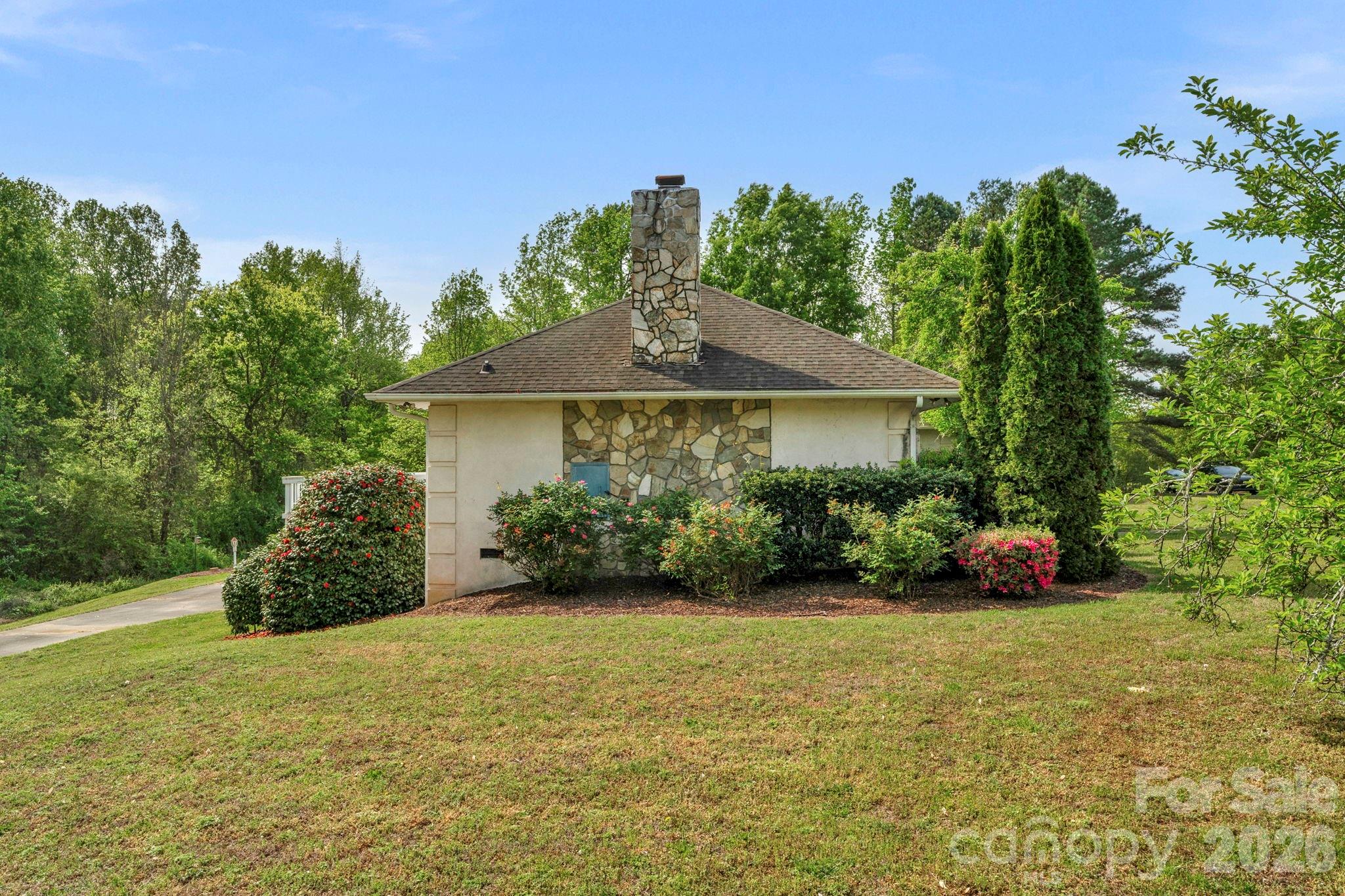 15015 Pawnee Trail Matthews, NC 28104 - Photo 28 of 39 a view of a garden with plants and a bench