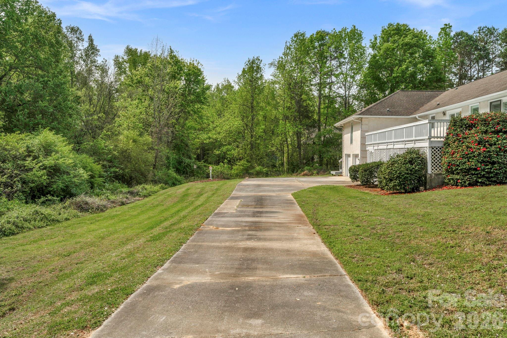 15015 Pawnee Trail Matthews, NC 28104 - Photo 32 of 39 a view of a house with a yard