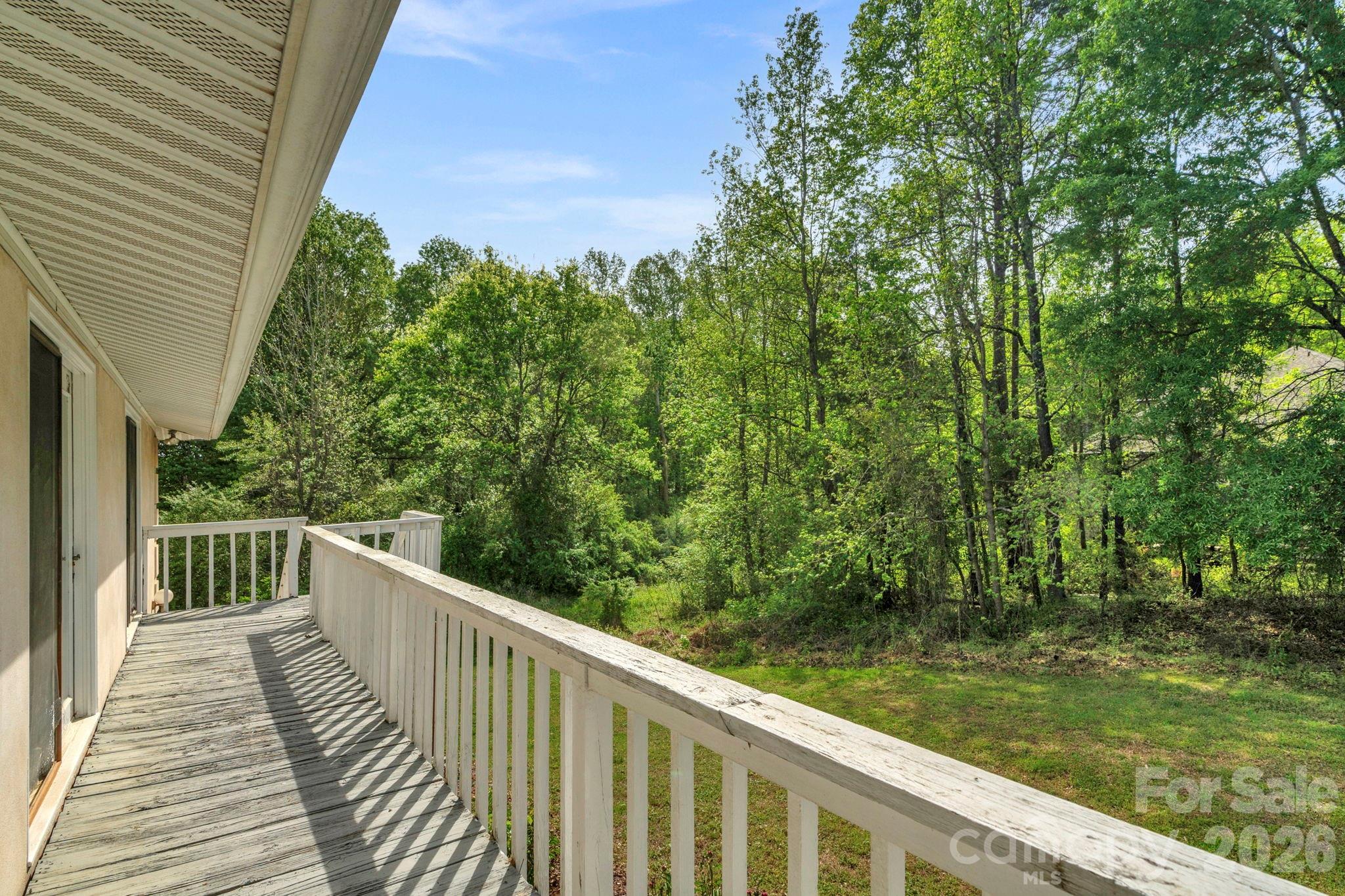 15015 Pawnee Trail Matthews, NC 28104 - Photo 39 of 39 a balcony with wooden floor and yard in the back