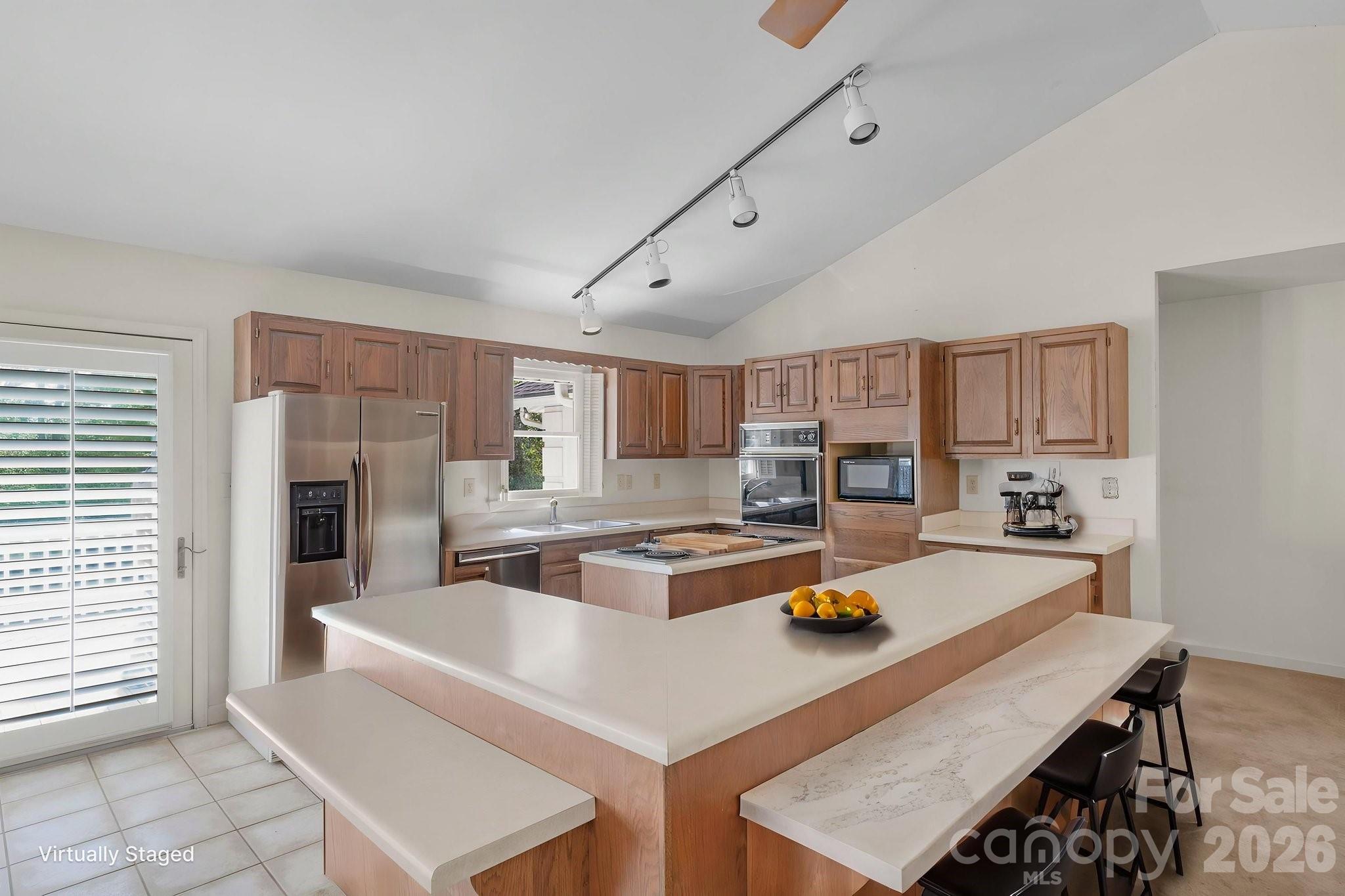 15015 Pawnee Trail Matthews, NC 28104 - Photo 6 of 39 a kitchen with a stove a sink dishwasher and a refrigerator with wooden floor