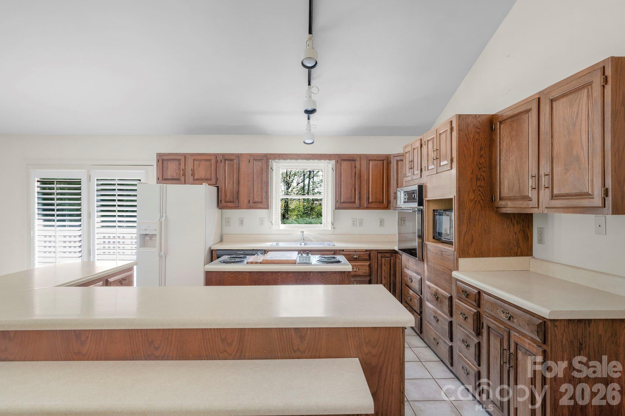15015 Pawnee Trail Matthews, NC 28104 - Photo 9 of 39 a kitchen with stainless steel appliances granite countertop a stove a refrigerator and a microwave