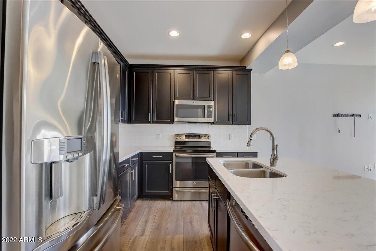 1282 East Curry Road Tempe, AZ 85288 - Photo 10 of 56 a kitchen with a sink appliances and cabinets