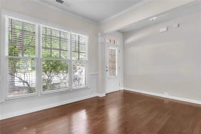 a view of wooden floor and windows in a room