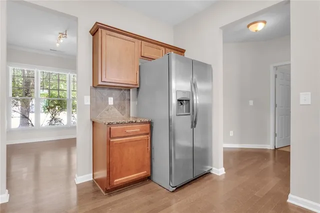 an empty room with windows and cabinet