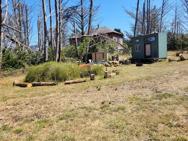 a view of a house with a yard covered in snow