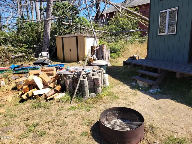 a view of a backyard with table and chairs