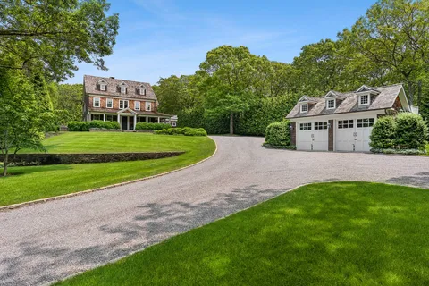 a view of a house with a yard and table