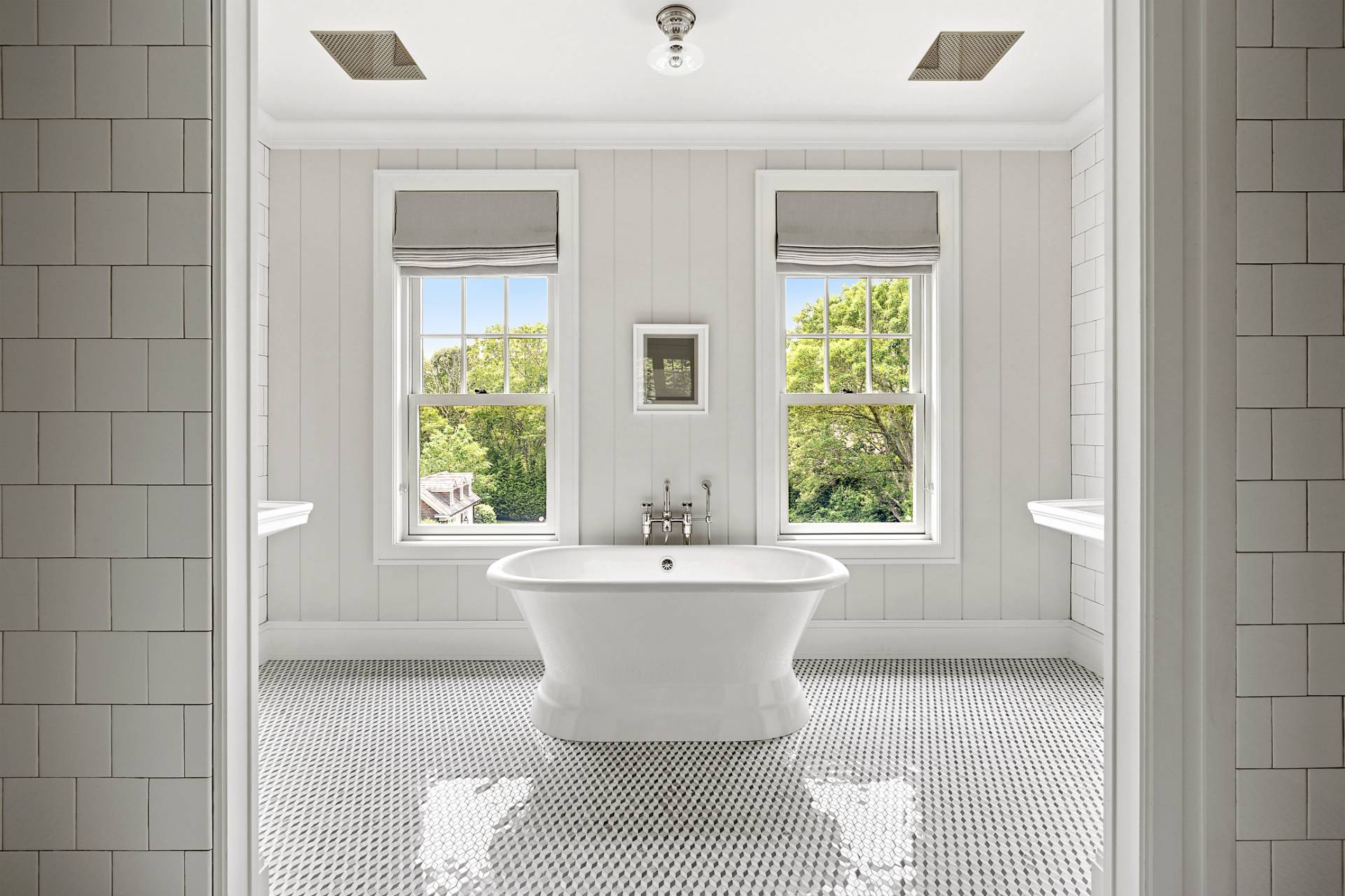 23 Wooded Path Sag Harbor, NY 11963 - Photo 11 of 25 a white bath tub sitting in a bathroom next to a window